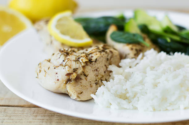 istock Chicken breasts with thyme, lemon, rice and spinach salad 598141720