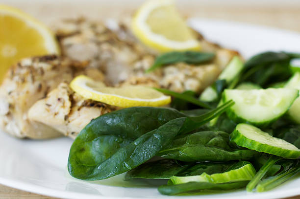 istock Spinach salad served with baked chicken meat and lemon slices 598141838