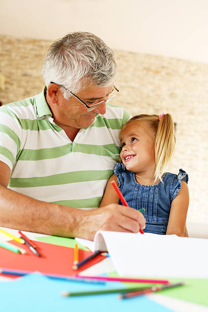 istock Grandfather working homework with granddaughter. 598142024
