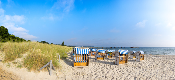 Sandy beach and traditional wooden beach chairs on island Rugen, Northern Germany, on the coast of Baltic Sea