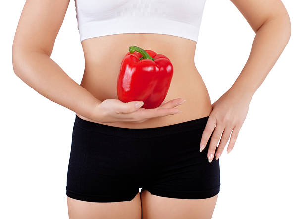 istock woman holding red bell pepper 598142110