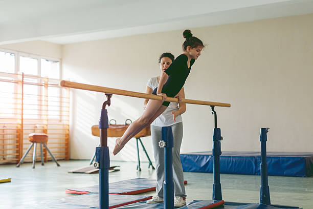 istock Girl Exercise On Gymnastics Bar. 598143110