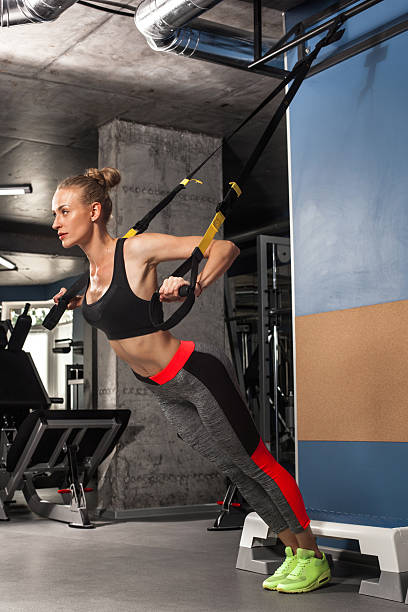istock Sport girl is engaged in exercises TRX 598143298