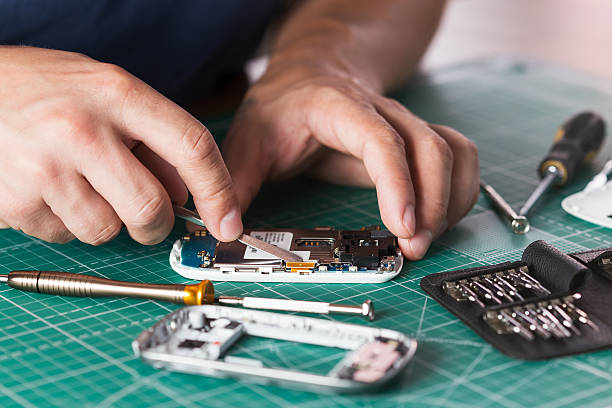 istock Man repairing broken smartphone, close up photo 598143478