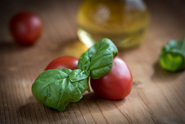 Fresh Basil Leaves and Tomatoes  with olive oil stock photo