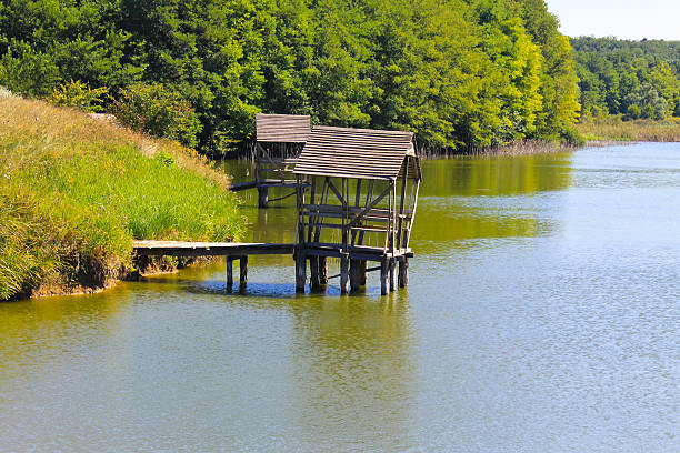 istock Gazebo on wooden pier on lake 598145982