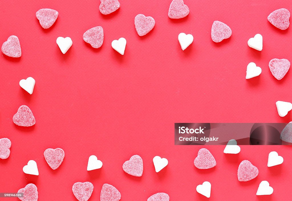 Festive red background and sweet sugar hearts, valentines day Festive red background and sweet sugar hearts, valentines day  Candy Heart Stock Photo