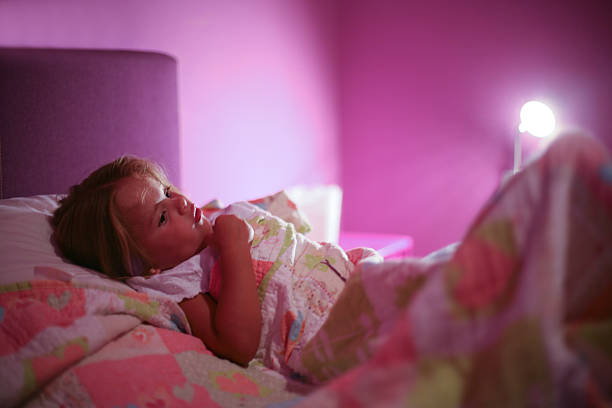 little girl preparing to sleeping in bed. - sleeping child bedtime little girls imagens e fotografias de stock