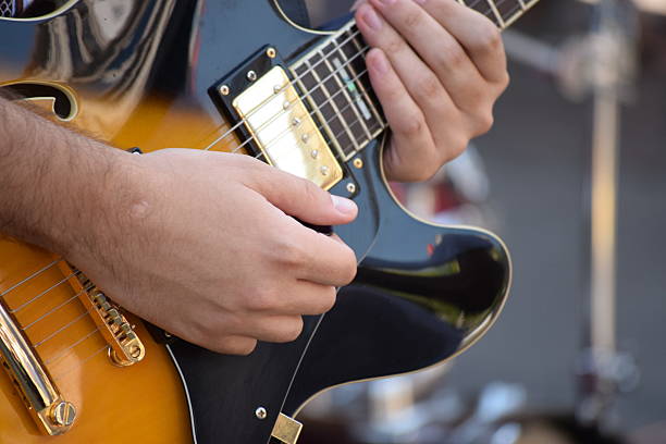 istock hands on the strings of electric guitars 598147188