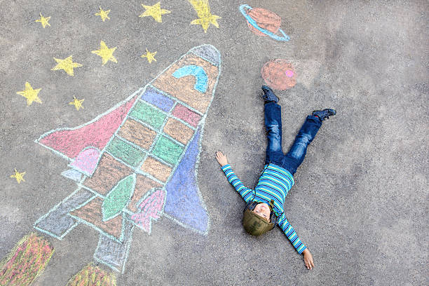 istock little kid boy flying by a space shuttle chalks picture 598148340