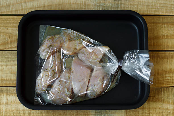 istock Raw chicken breast slices marinaded in lemon juice, pepper 598149934