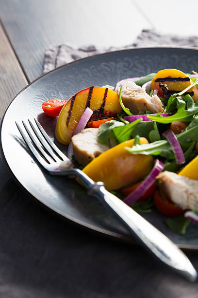 istock Salad of chicken, fried peach and arugula 598152066