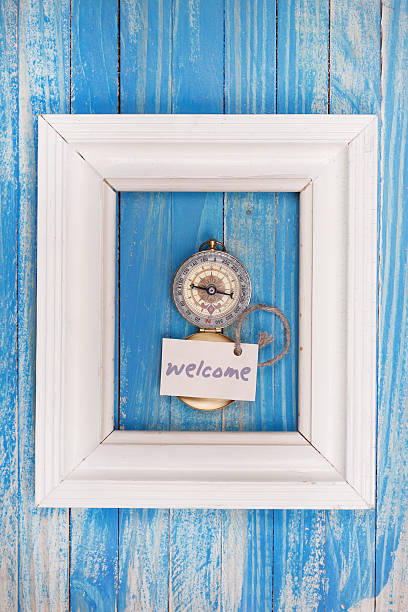 Sign Welcome and Compass in a white frame stock photo