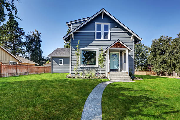 istock Blue clapboard siding house with grass filled front yard. 598155494