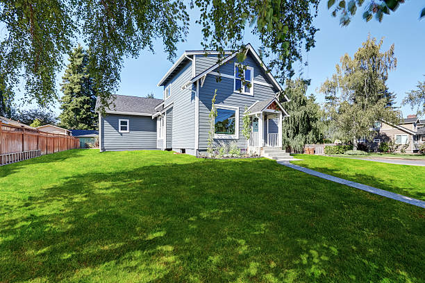 istock Blue clapboard siding house with grass filled front yard. 598155586