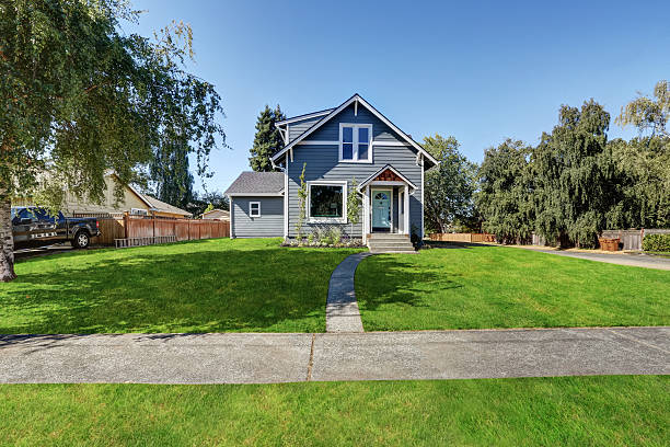 istock Blue clapboard siding house with grass filled front yard. 598155668