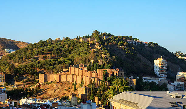 Malaga Alcazaba and Gibralfaro at sunset The hill at the east of the old town of Malaga at sunset, with the moorish Alcazaba at the bottom and the Gibralfaro castle at the top of the hill. alcazaba of málaga stock pictures, royalty-free photos & images