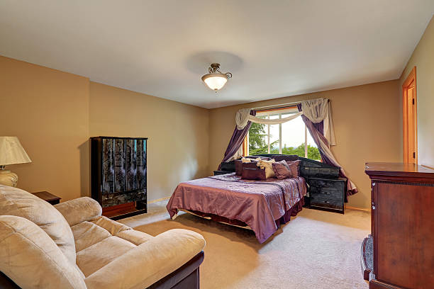 istock Master bedroom interior with purple queen size bed. 598159584