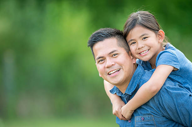 istock Father Giving His Daughter a Piggy Back 598162636