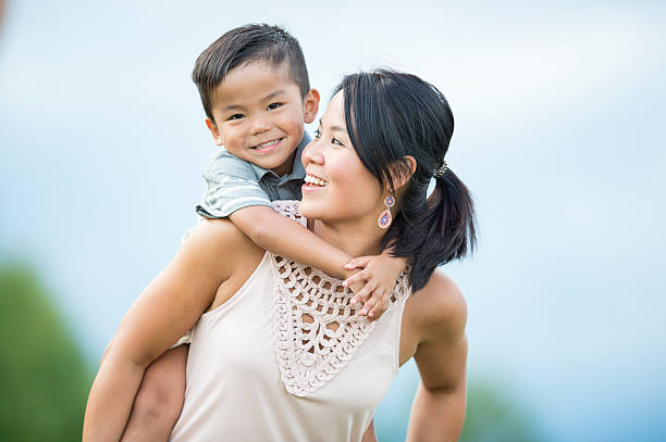 istock Little Boy Holding onto His Mother 598162650