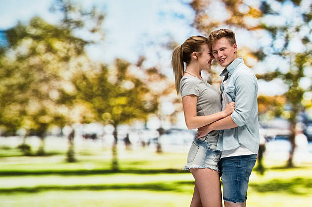Beautiful young couple on date in the park during the day