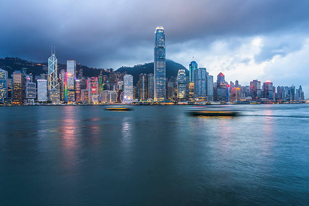 istock modern illuminated buildings along coastline,hong kong 598164244