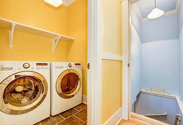 istock White Modern appliances in small yellow laundry room 598164682