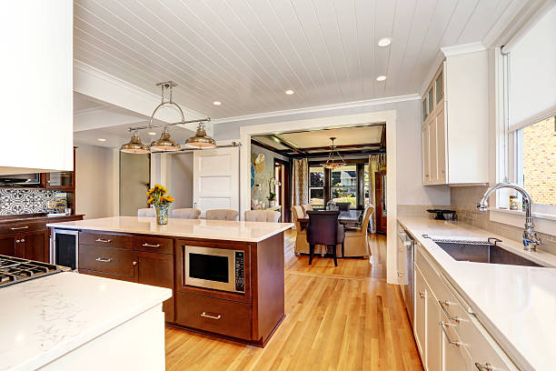 istock White interior of kitchen room with large kitchen island. 598165132