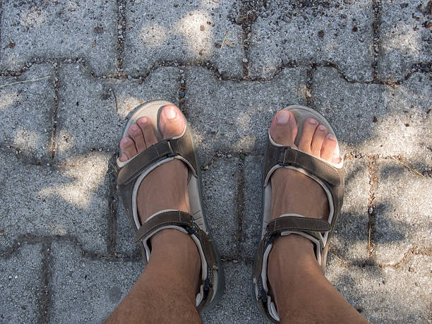 istock Take Direction ? On the Sidewalk Naked Legs and Sandals 598165404