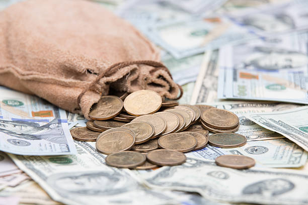 istock Golden dollar coins spilling from a bag 598167326