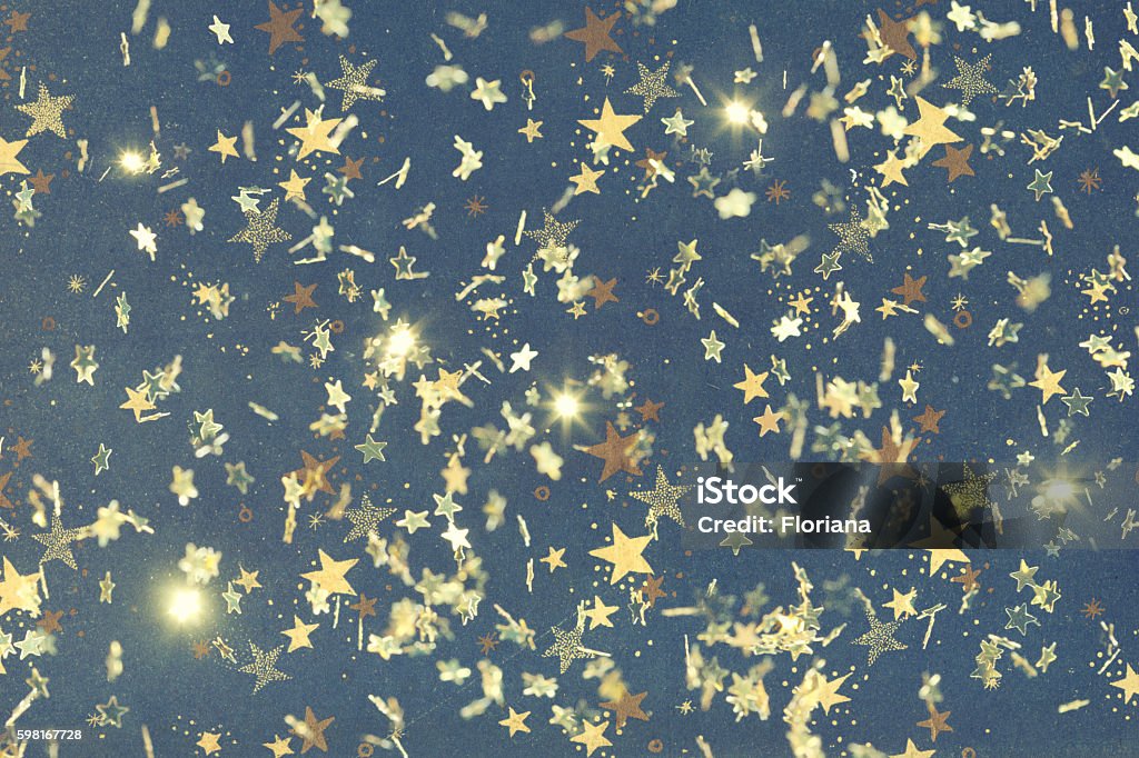 golden holiday background Golden stars falling over a vintage paper decorated with stars, selective focus. Wrapping Paper Stock Photo