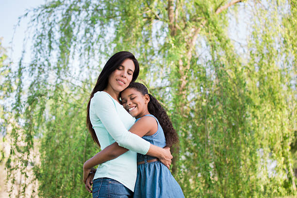 istock Mother and daughter embracing with eyes closed 598167952