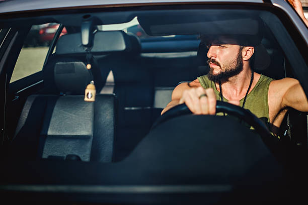 istock Hipster man driving a car on a sunny day 598168824