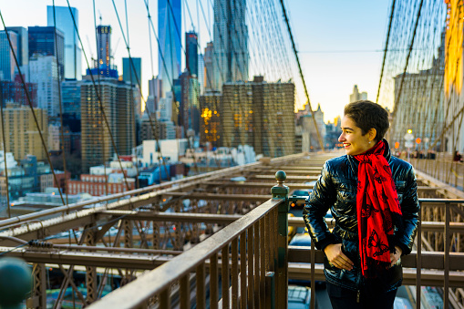 Pretty young woman. tourist, at the Brighton Bridge, New York City, USA