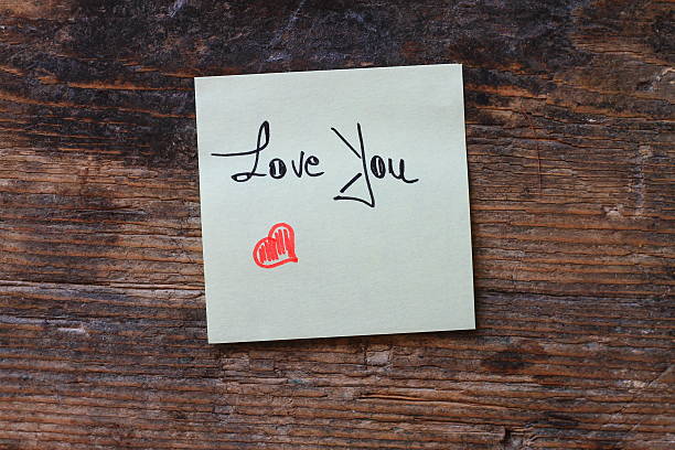istock Message Love You with small red heart on wooden table 598169766