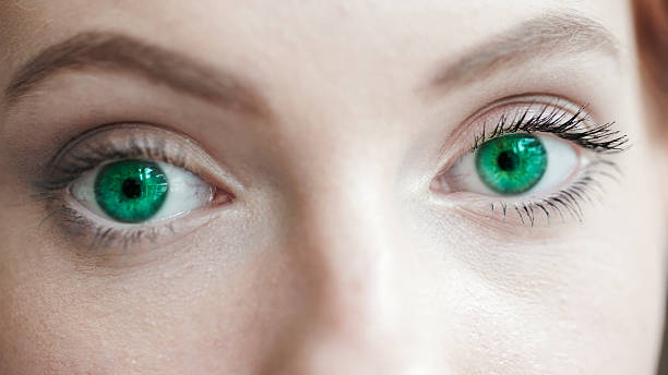 istock Woman's eye with green contact lens 598169912