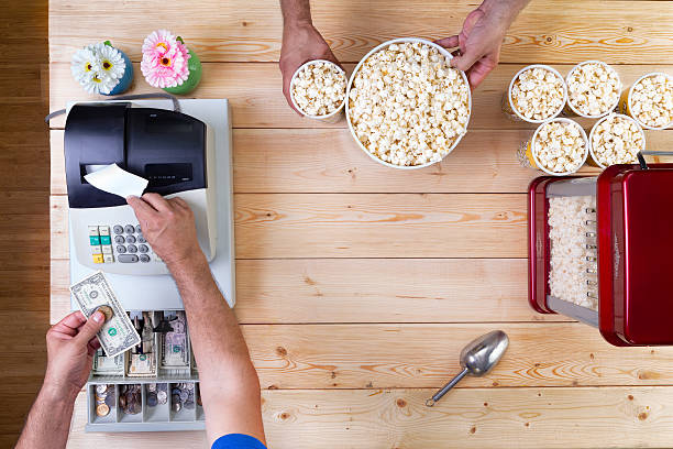 Man selling freshly made bowls of popcorn