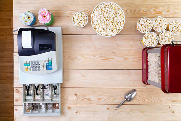 istock Bowls of fresh popcorn alongside a till 598170714