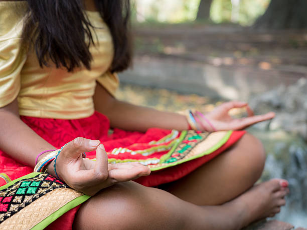 istock Hindu woman meditating in the park 598170976