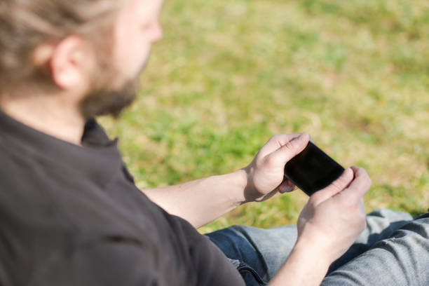 istock young man holding smart phone 598171164
