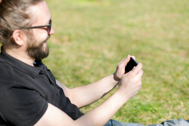 istock Happy Young Man With Smart Phone In The Park 598171202