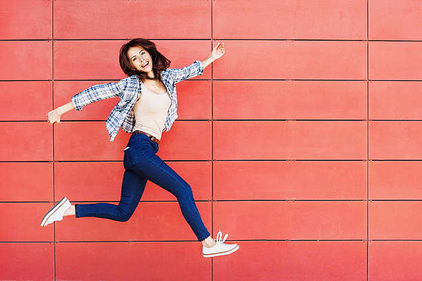 istock Jumping happy girl 598171700