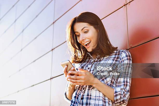 Surprised Girl Using Smart Phone Stock Photo - Download Image Now - Mobile Phone, Surprise, Women