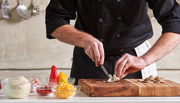 istock Restuarant hotel private chef cutting mushrooms on board 598172662