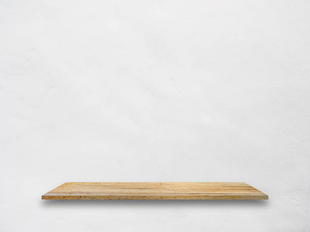istock Wooden shelf on white concrete wall 598173256