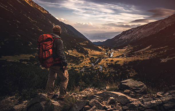 istock Traveler watching the sunset over the mountains 598173612