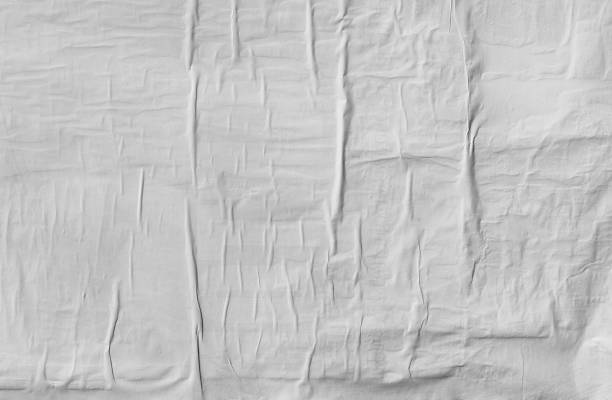 istock Wrinkled paper glued on wall texture 598173728