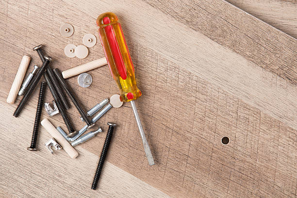 istock Screwdriver and Hardware Scattered on Wood Planks 598175892
