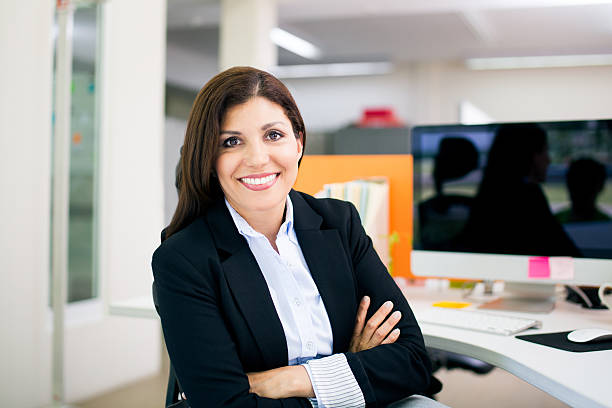 istock Office manager smiling at camera with arms crossed 598176180