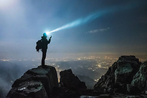 Hiker checks your device on top on the mount Hiker on top on the mount, fog and cloud checking sports stock pictures, royalty-free photos & images